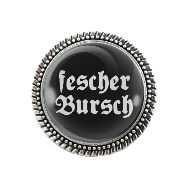 Schwarze Trachtenbrosche mit silberner Fassung und weißem Spruch „fescher Bursch“