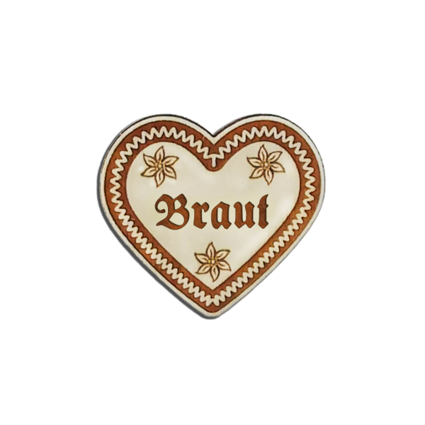"Verleihen Sie"Verleihen Sie Ihrem Outfit bayrisches Flair mit unserem 'Braut' Lebkuchenherz-Anstecker - erhältlich bei Glubbal.shop"Ihrem Outfit bayrisches Flair mit unserem 'Lausbua' Lebkuchenherz-Anstecker - erhältlich bei Glubbal.shop"