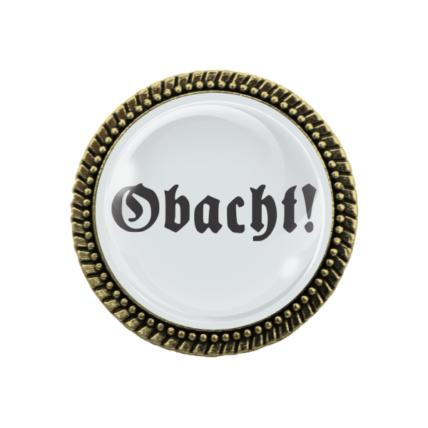 Nahaufnahme der Gaudibroschn 'Obacht' – hochwertiger Schmuck in Bronze